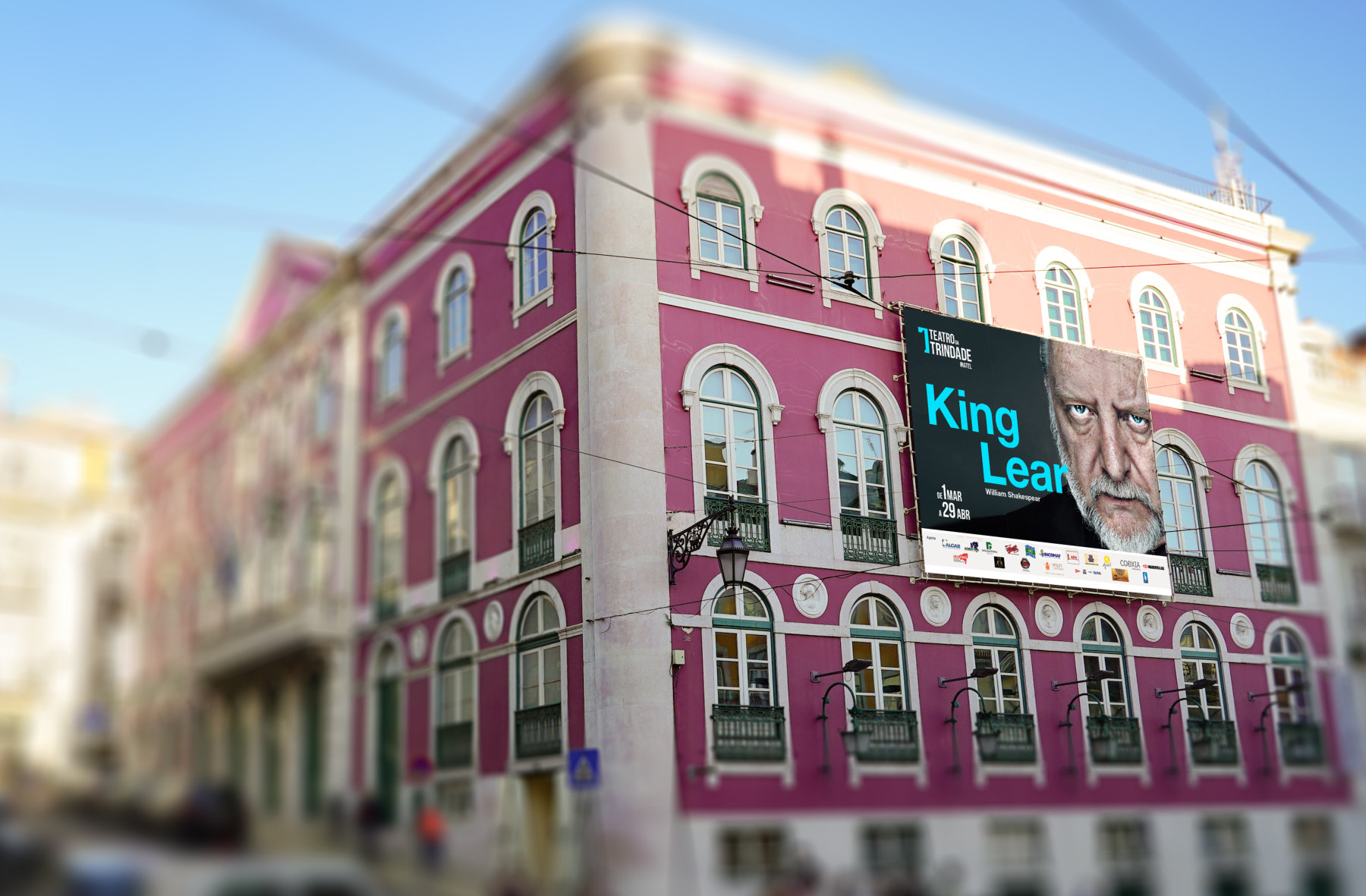 Simulação da identidade do Teatro da Trindade aplicada à fachada, com cartaz King Lear.